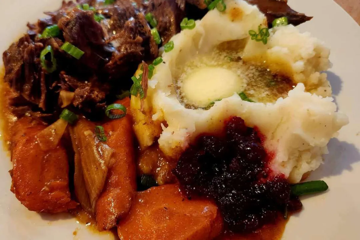 Deer pot roast served with vegetables on a platter