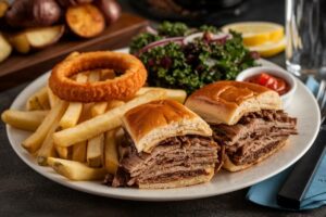 Philly cheesesteak sliders with fries, onion rings, kale salad, and roasted potatoes